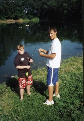 Mick at Y Camp Getting a Fishing Lesson - Photo from Camp Staff