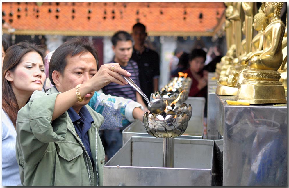 Burning oil as an act of worship to Buddha