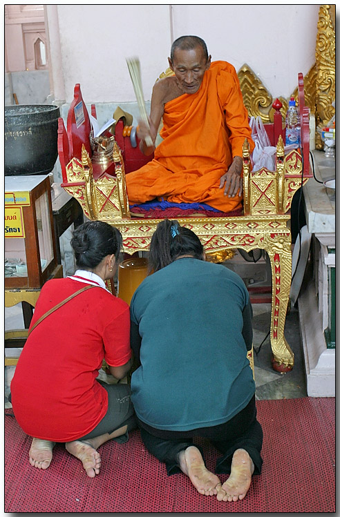 Temple monk at the Prapatom Chedi blessing the faithful
