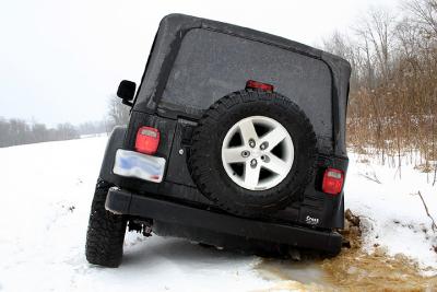 Not much of a chance to get out, I needed help. Note drivers side tires barely making contact with the ice too.