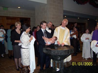 Father John baptizing Evan