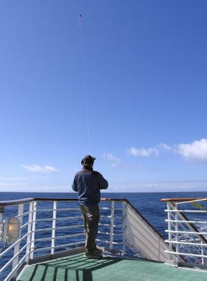 Kite-flying (!) on a balmy day in arguably (and ordinarily) the roughest body of water on the face of the earth.