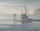 Fishing boat in the mist