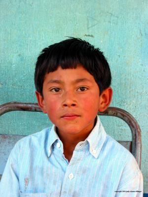 boy against turquoise wall, santa maria de jesus, guatemala