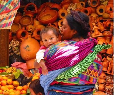 woman in front of pots, antigua market, guatemala