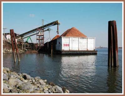 Loading barge with wood chips.
