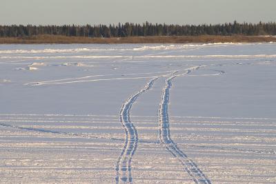 Deep snowmobile tracks in new snow
