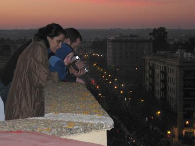 Luis with neighbour Marieugenio on roof watching parade