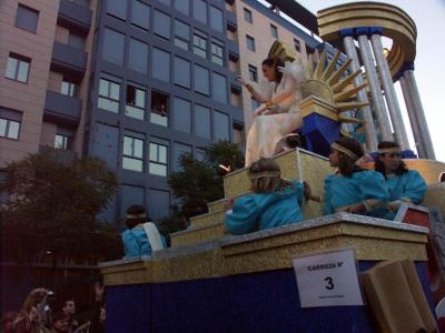 Floats with various themes pass and throw out lollies