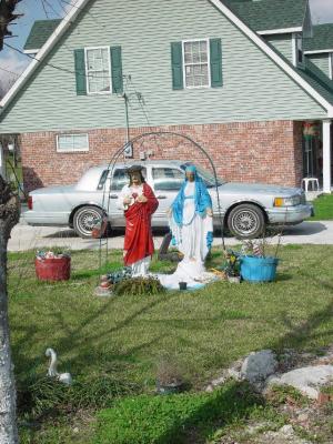 THE FOLKS IN CAJUN COUNTRY LOVE THEIR STATUES OF VIRGIN MARY AND THE SACRED HEART IN THE FRONT YARD AND NO BATH TUBS USED