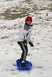 Casie snowboarding on sled