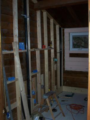Since the walls are solid cedar, we had to frame in a false wall to run electrical and plumbing.