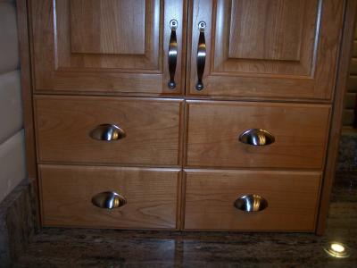 Detail of cabinet hardware. Satin nickel cup pulls and handles.
