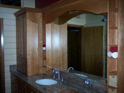 Vanity top, mirror, decorative shelves, and linen cabinet.