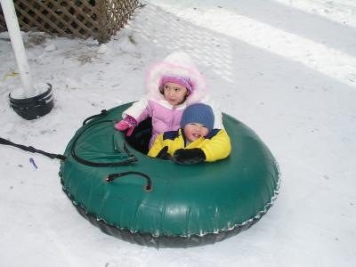 Kyle and Sarah going for a ride in a snowtube