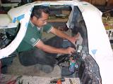 Armando in the car making the timing cover ( Being short has its advantages)