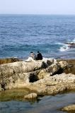 Sitting on the rocks along the Mediterranian