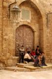 Local kids hanging out in front of an ornate door in medieval Sidon