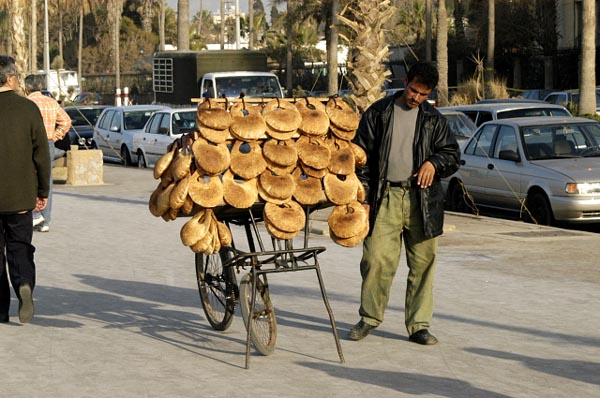 Vendor on the Corniche selling Kaak, eaten with a sweet cheesy pastery called kunafeh