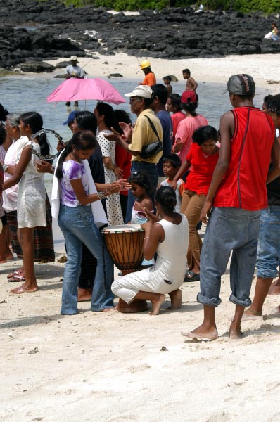 African drummer on the public beach for the baptism