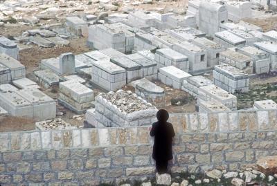 Rabbi Throwing Stones at Graves of Loved Ones -- As He is Not Permitted to Enter a Cemetery