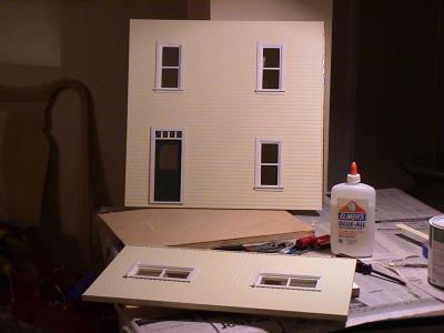 Gluing in the windows and door on 
the front wallls.
