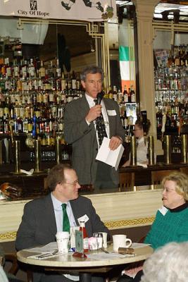 MC Dick Foley in background with Seattle Mayor’s Communications Dirtector Casey Corr and City Councilmember Jean Godden