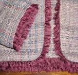 Close up of mauve plaid with ruffle.