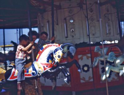 Lorraine, Steve, and Greg at amusement park; Calif., 1950