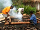 Rocks being added to cooking fire