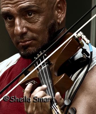 Close up of busker with violin