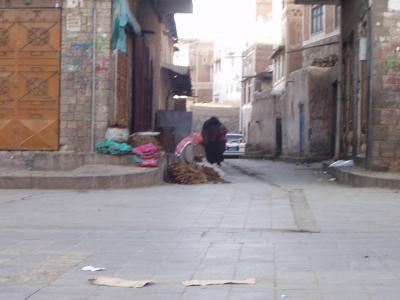 Tobacco seller, across from the curb i sat on every morning drinking coffee. That's a woman coming towards him