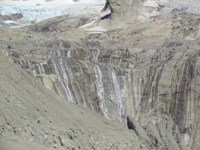 Glacial water running down the walls of the rock base