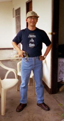 At Nita's home in the Philippines, gun in hand (!), July 1999