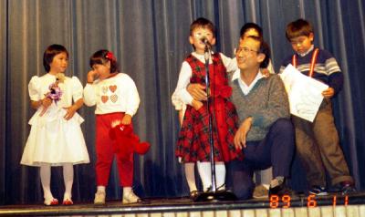 Caroline bringing dad on stage for Show-and-Tell, 1989
