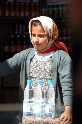 Yemeni girl working in a small shop at Wadi Dhahr