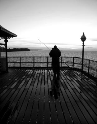 fisherman on Clevedon Pier - sunset BW.jpg