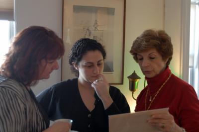 Linda, Lara and Jocy study an old family photo