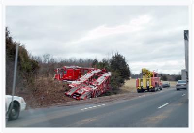 Car carrying tractor trailer in median