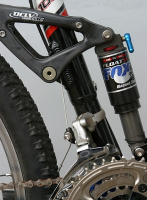 Close up of the rear suspension on a Trek Fuel 100, a dual suspension mountain bicycle.  The frame is aluminum and carbon fiber.