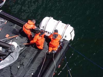 Move liferaft canister into position