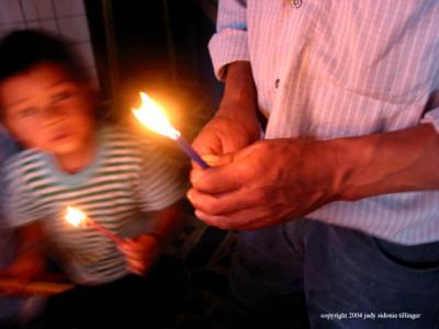 father and son with candles, san andreas iztapa, guatemala