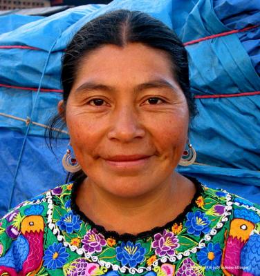 market woman against blue, antigua, guatemala
