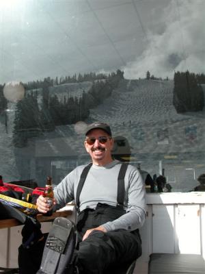 Sunning outside of Merry Go Round Restaurant and having a beer before the last run of the day.
You can see the mountain's reflection in the window behind Mike.