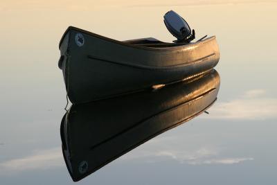 Northwest canoe and reflection in water