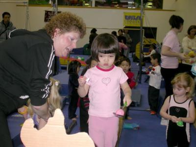 Walking on a balance beam and feeding balloon snacks to Scooby-Do