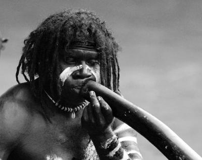 Aboriginal didgeridoo player in monochrome