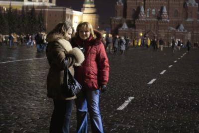 Two girls examining the LCD after shot