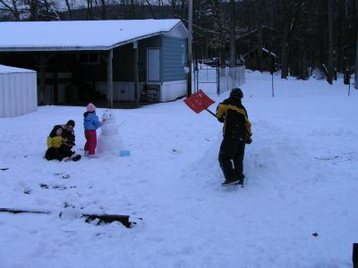 Kyle, Sarah, Emily, and Nick building a snowman