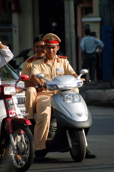 Vietnamese officials on a scooter